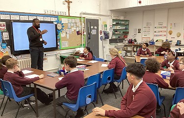 Artist Mfikela Jean Samuel giving a presentation to year 5 and 6 pupils