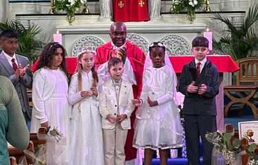 Blessed William Davies Catholic Primary School pupils celebrating their First Holy Communion 2025 standing at the alter