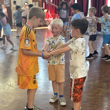3 students dancing together