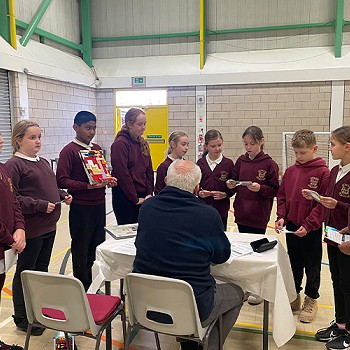 Year 5 and 6 pupils talking to one of the judges of the LEGO league competion