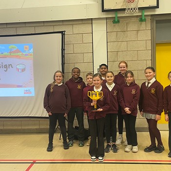 Year 5 and 6 pupils with a trophy after taking part in LEGO league competion
