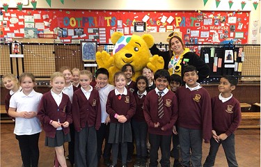 Pudsey Bear with group Blessed William Davies pupils standing in a classroom