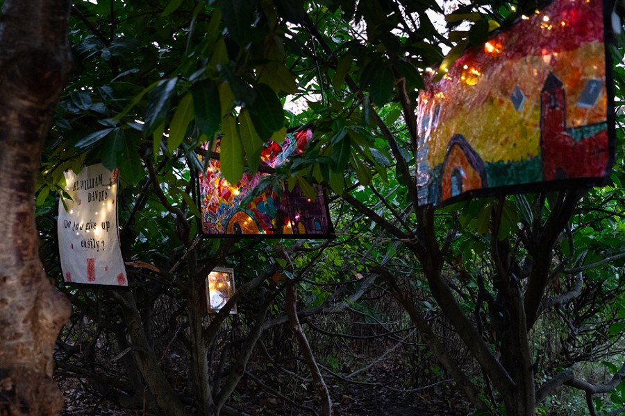 3 pieces of student artwork in the garden