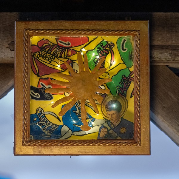 framed artwork with a sun in the middle